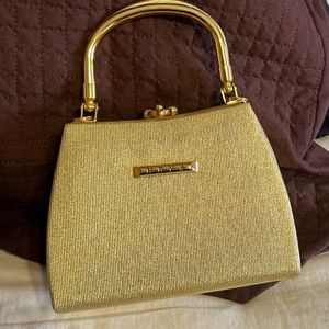 Small, shiny, dressy gold purse by HEYS